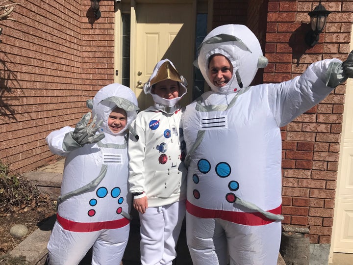 Poppy Anderson, left, Atlas Anderson, centre, and mom Kat Anderson dress up in costume for a neighbourhood stroll.