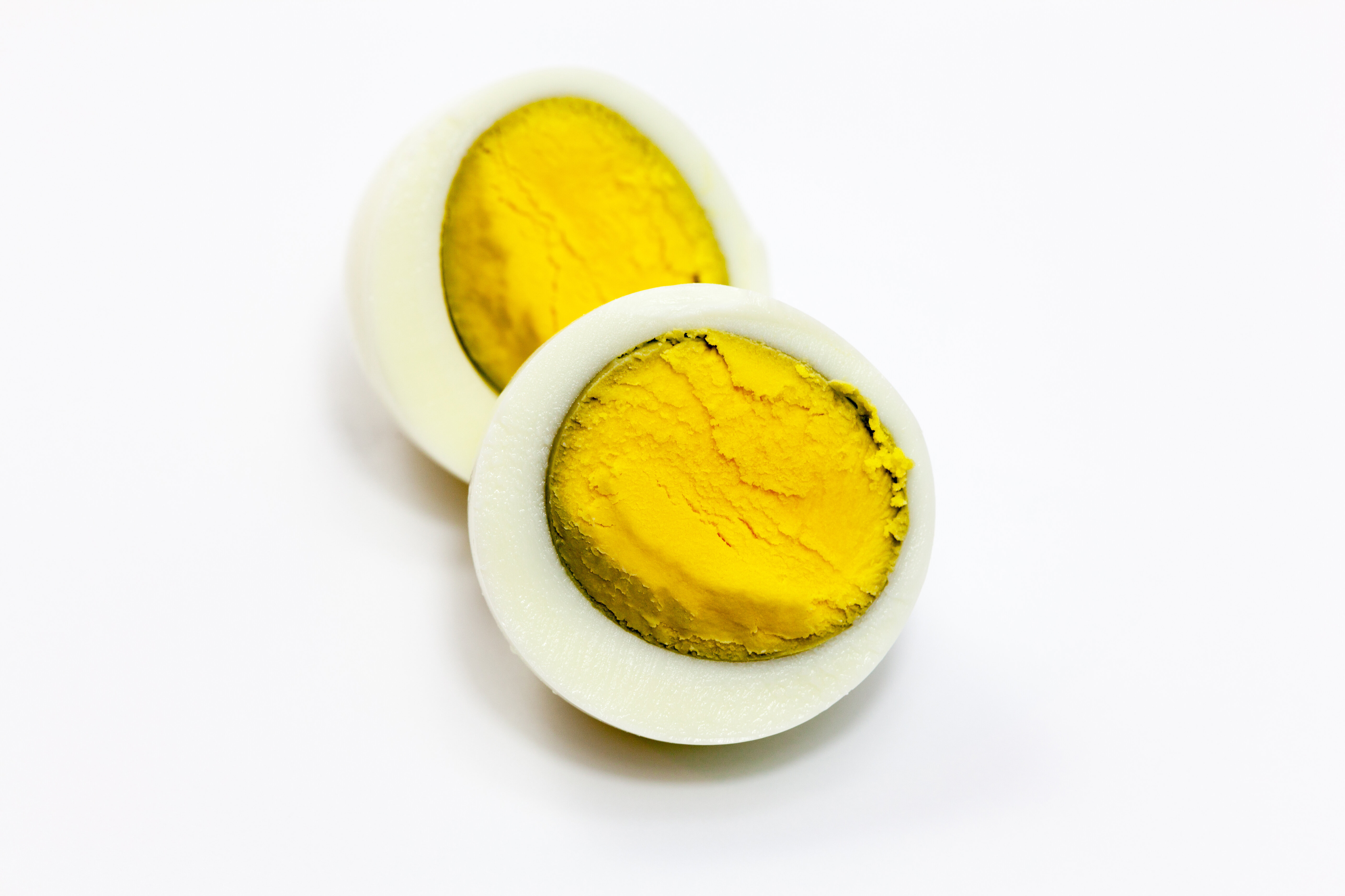 A hard-boiled egg with a dark ring around the yolk due to overcooking.