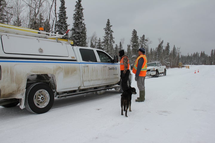 Security personnel stop an industry worker at a checkpoint set up at an entrance to the Waterhen Lake First Nation in Saskatchewan. 