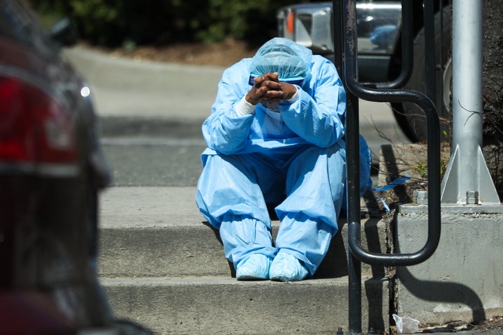 A sad and tired healthcare worker is seen by the Brooklyn Hospital Center in New York, United States on April 1, 2020. (Photo