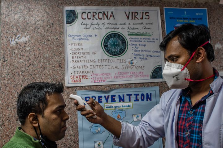 A doctor examines a patient in an area set aside for possible coronavirus cases during a free screening camp at a government homeopathic hospital on March 16, 2020 in New Delhi. 