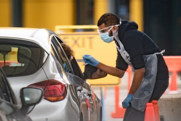 NHS staff at a drive-through coronavirus testing facility.