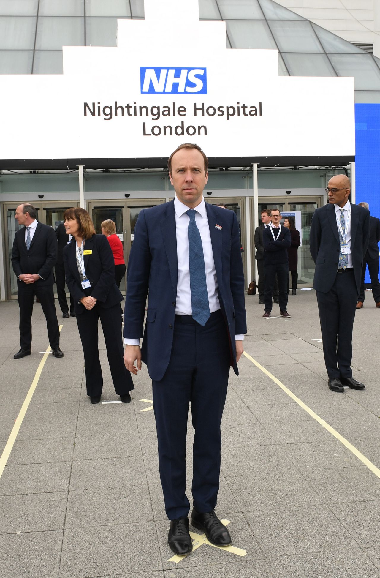 Health secretary Matt Hancock and NHS staff stand on marks on the ground to ensure social distancing guidelines are adhered to at the opening of the NHS Nightingale Hospital at the Excel centre in London