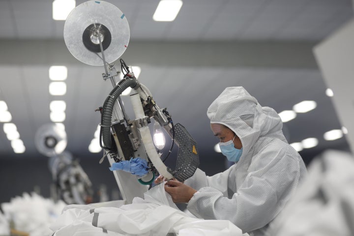 An employee works on a production line manufacturing protective suits at a medical supply factory in Xinzhou district of Wuhan, China February 12, 2020.