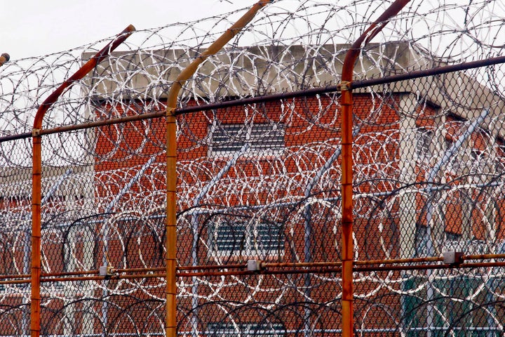 In this March 16, 2011, file photo, a security fence surrounds inmate housing on the Rikers Island correctional facility in N