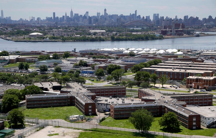 This June 20, 2014, file photo shows the Rikers Island jail complex with the Manhattan skyline in the background.