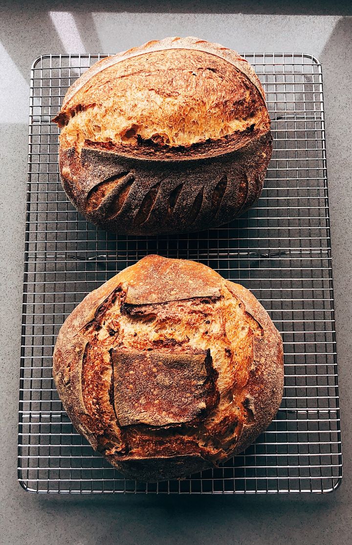 Two finished loaves of beautiful sourdough bread.