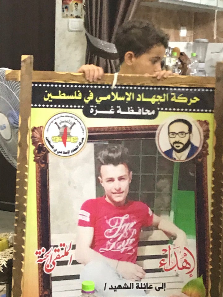 In Gaza, a poster for a child killed by an Israeli air strike bears the name of one of the militant groups that dominate the 