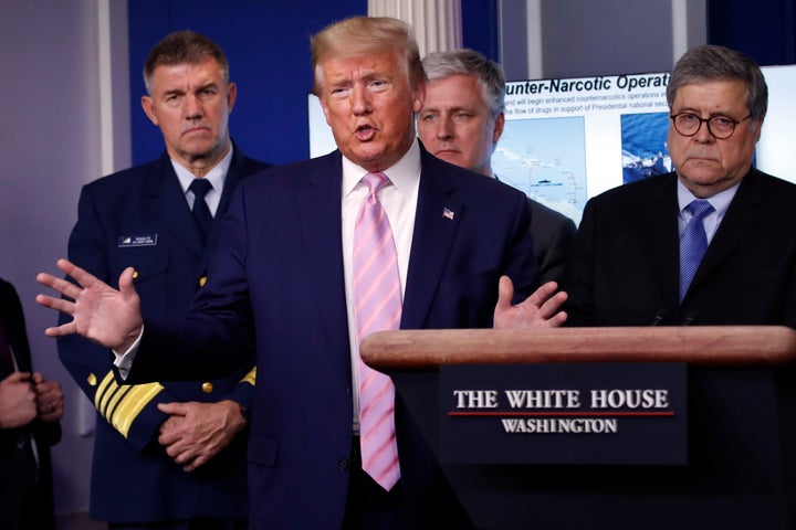 President Donald Trump speaks about the coronavirus on April 1, 2020, as (left to right) Adm. Karl Leo Schultz, commandant of the Coast Guard, national security adviser Robert O'Brien and Attorney General William Barr listen closely.