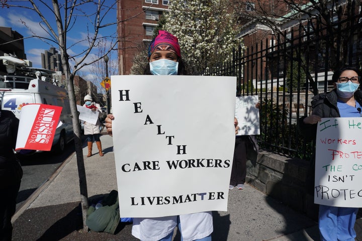 Members of the medical staff listen Wednesday as Montefiore Medical Center nurses call for N95 masks and other critical prote