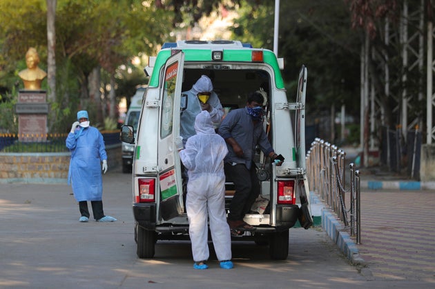 A man with Covid-19 symptoms gets down from an ambulance at the Government Gandhi Hospital in Hyderabad,...