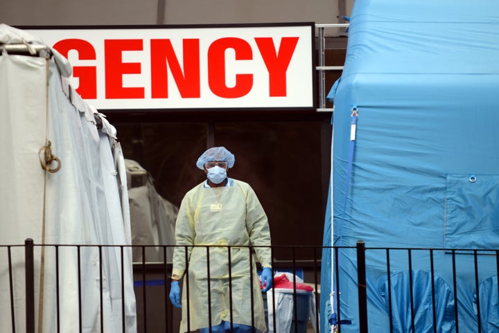 A doctor stands in the middle of the makeshift COVID-19 screening center outside Elmhurst Hospital in Queens, New York. 