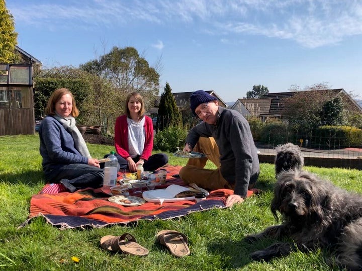 Kate and her parents in their garden.