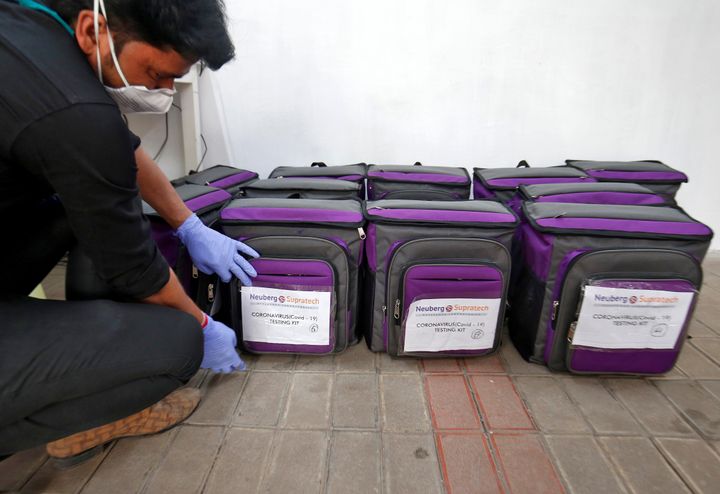 A laboratory technician places a tag on a box containing coronavirus disease (COVID-19) testing kit at a sample collection centre in Ahmedabad, India March 26, 2020. REUTERS/Amit Dave