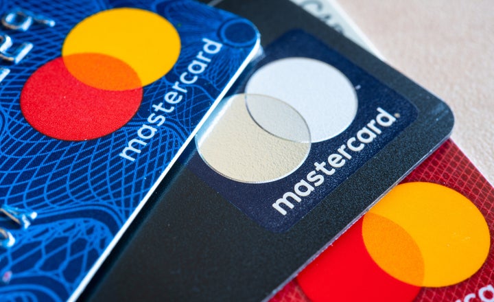 Three MasterCard credit cards of varying colours are seen in this stock photo.