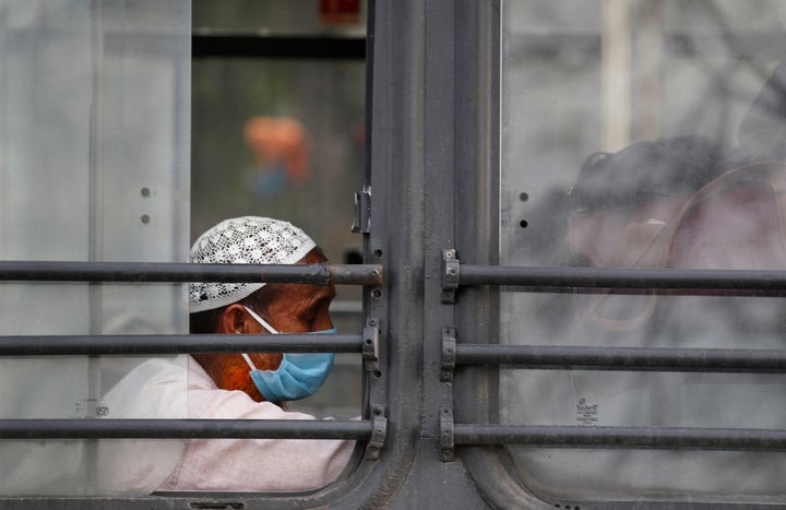 Muslim pilgrims wait in a bus that will take them to a quarantine facility, amid concerns over the spread of the coronavirus in Nizamuddin, New Delhi, on March 31, 2020. 