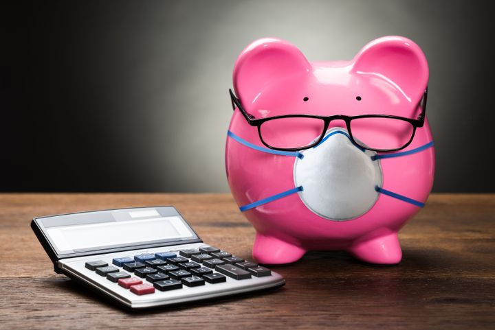 Pink Piggybank With Calculator On Wooden Table