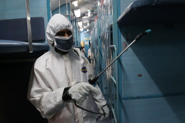 A worker in protective gear sprays disinfectant inside a train carriage converted into an isolation ward for COVID-19 patients during the countrywide 21 day lockdown amid concern over the spread of coronavirus in Howrah.