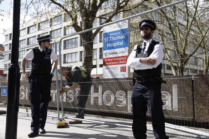 Police officers stand guard outside St Thomas' Hospital in London where Boris Johnson is in intensive care.