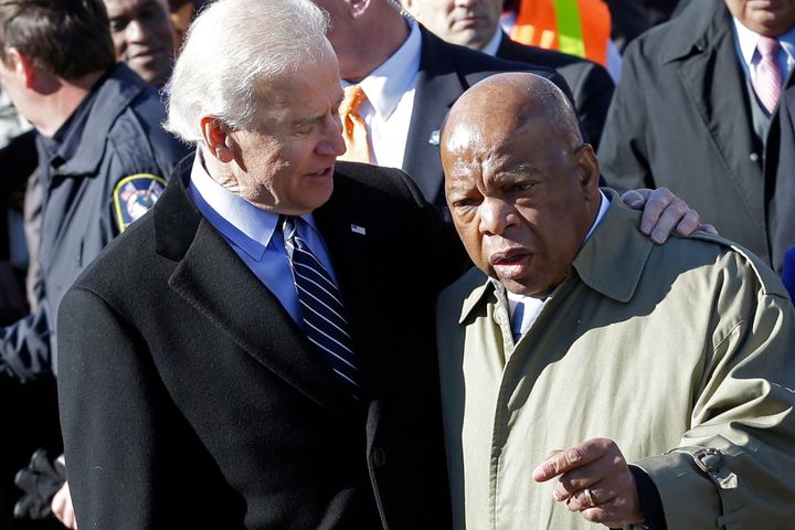 In this March 3, 2013, file photo, Vice President Joe Biden, left, embraces U.S. Rep. John Lewis, D-Ga., as they prepare to lead a group across the Edmund Pettus Bridge in Selma, Ala. 