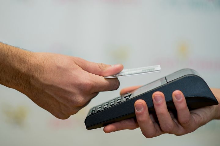 A touchless transaction is seen here in this undated stock photo. Credit card purchases cost retailers more than debit or cash.