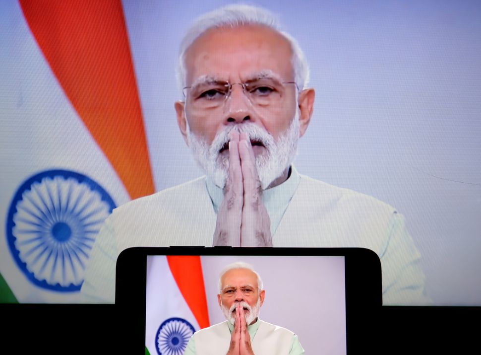 In this photo illustration, Indian Prime Minister Narendra Modi seen on a smartphone screen appealing to Indian people to light candles amid Coronavirus out break. 