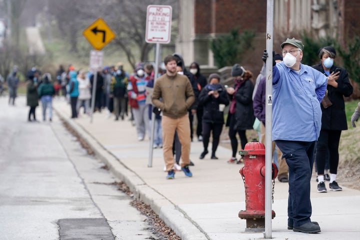 Voters masked against coronavirus line up at Riverside High School for Wisconsin's primary election, April 7 in Milwaukee.