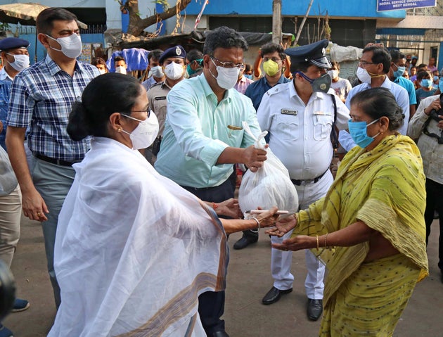 West Bengal Chief Minister Mamata Banerjee distributes food and essential commodities to the homeless...