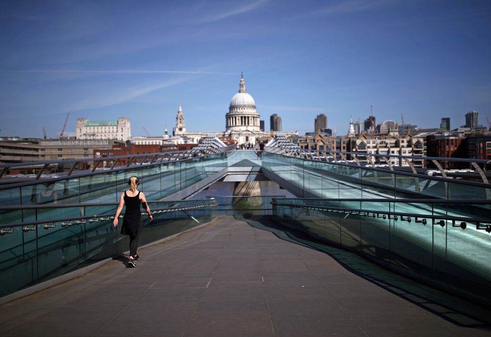 A jogger on the Millennium Bridge in London, as the UK continues in lockdown to help curb the spread of the coronavirus.