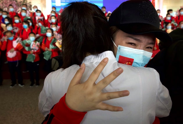 A medical worker from China's Jilin Province reacts as she prepares to return home at Wuhan Tianhe International