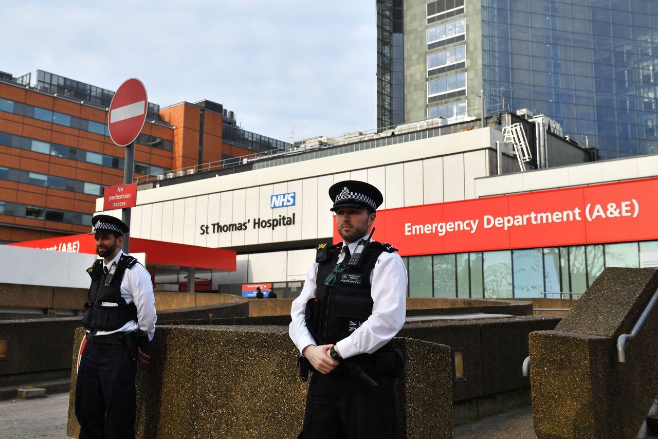 Police officers outside St Thomas' Hospital in Central London, where Johnson remains is being treated.