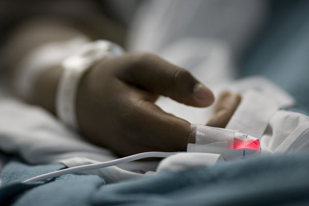 Close-up of a patient's hand in a hospital bed