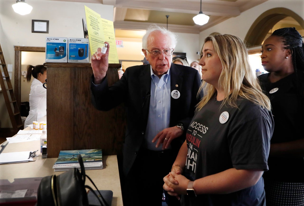 Sanders holds an insulin vial as he talks with Quinn Nystrom at the Olde Walkerville Pharmacy on July 28, 2019, in Windsor, Ontario. Sanders and a busload of insulin patients stopped in Windsor to purchase the drug to highlight its high costs in the U.S.