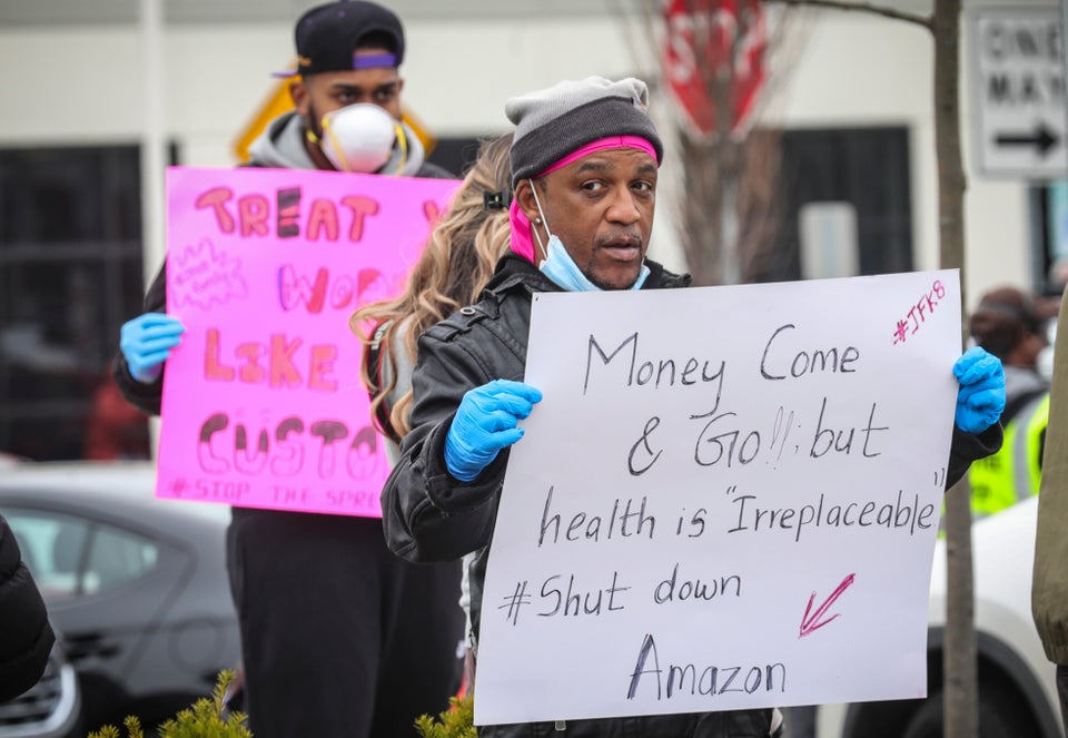 Gerald Bryson, left, join workers at an Amazon fulfillment center in Staten Island, New York, protesting...