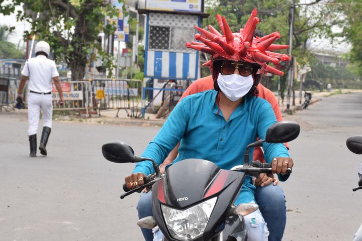 Volunteers wearing a coronavirus-themed outfit composed of helmet to raise awareness about the coronavirus in Kolkata.