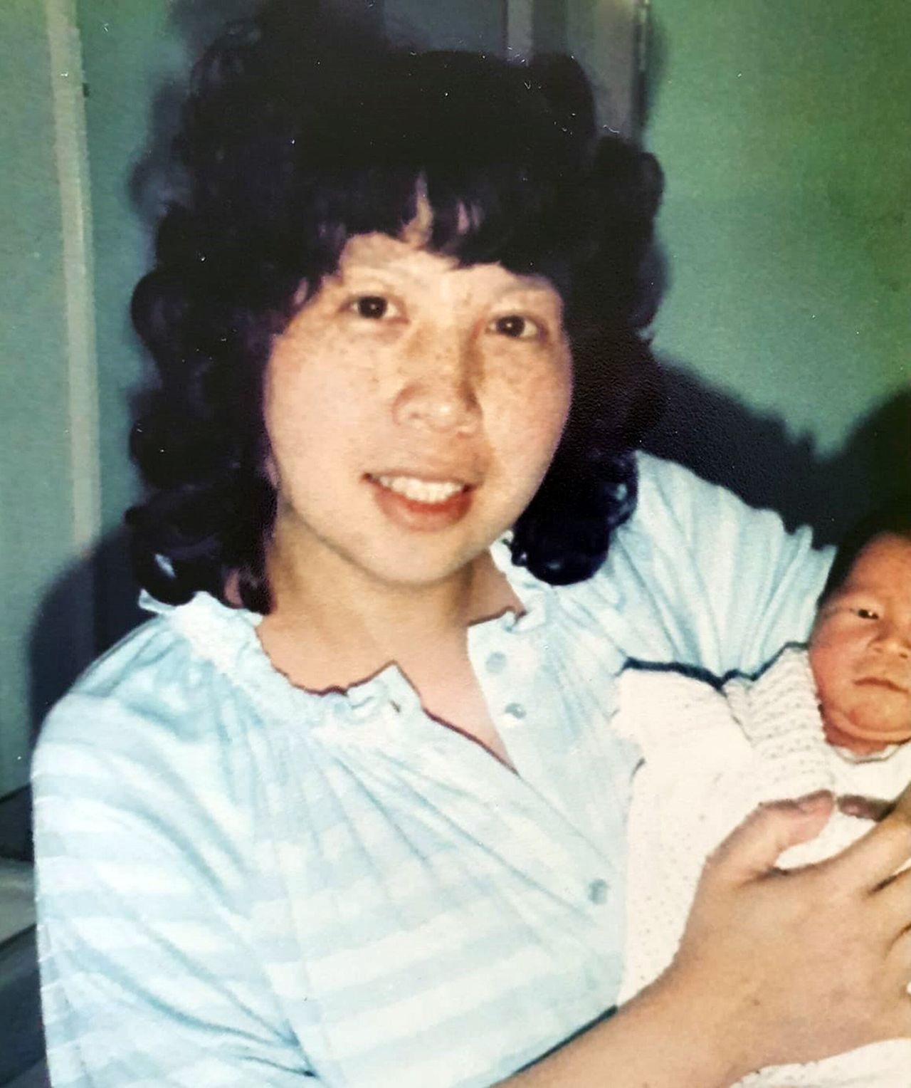 Alice Kit Tak Ong holding her daughter Melissa as a baby.