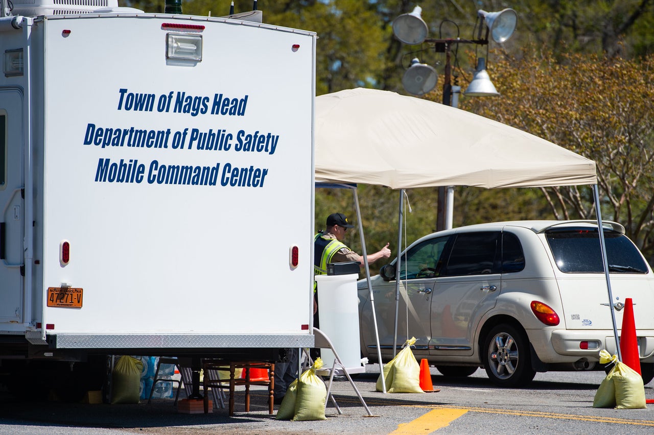 An officer gives a thumbs-up approval for entry into the Outer Banks at the southern end of the Wright Memorial Bridge. 