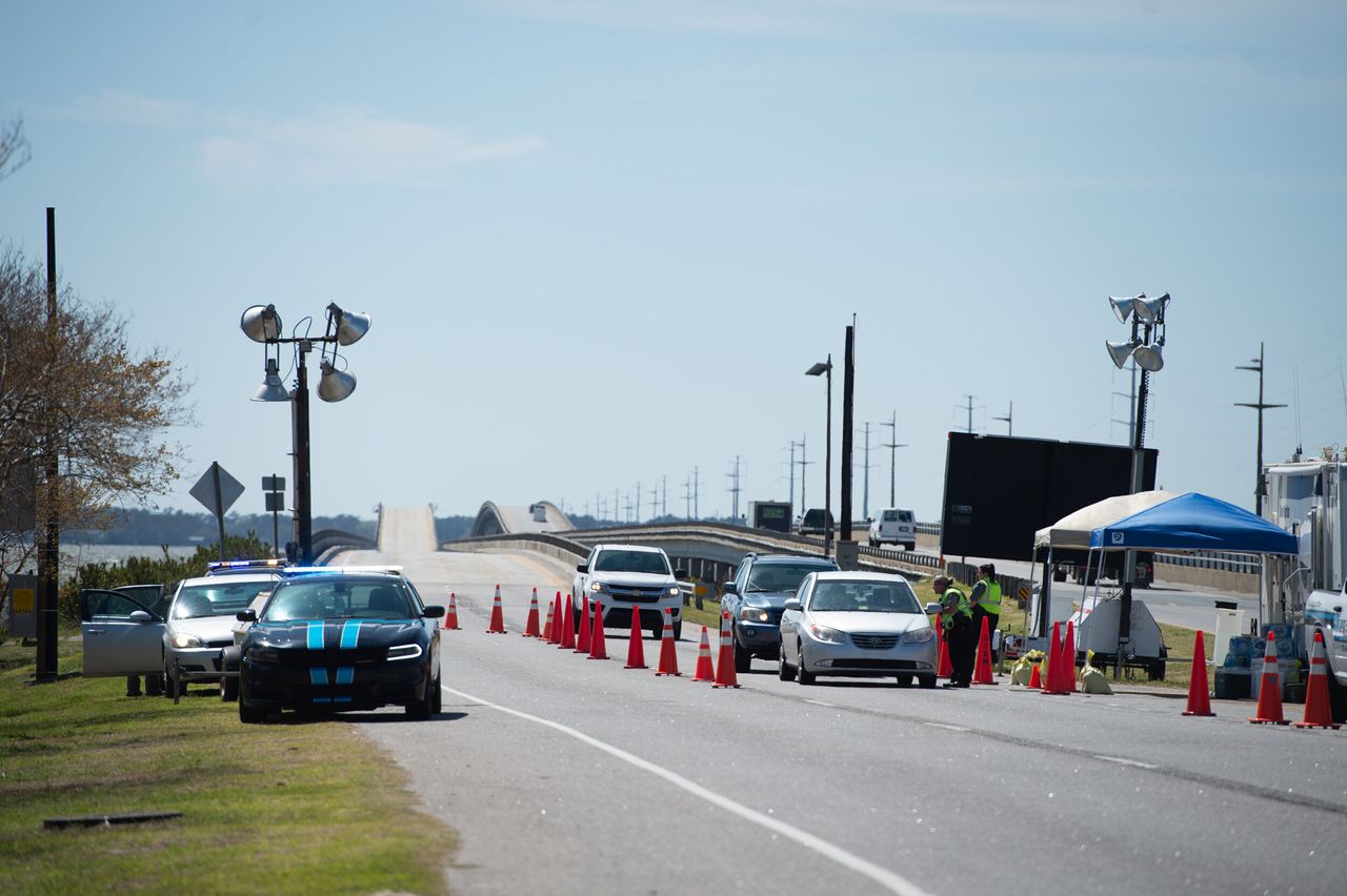 A roadblock checkpoint is set up in Kitty Hawk at the southern end of the Wright Memorial Bridge, which connects the Outer Banks to the North Carolina mainland. Here officers stop all in-bound vehicles and screen drivers' identification to determine whether they meet COVID-19 restrictions for entry into the Dare County Outer Banks.