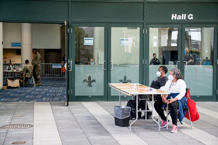 Louisiana Health Department Nursing Staff wait to check IDs and take temperatures of people wishing to enter the New Orleans Ernest N. Morial Convention Center on April 6, 2020.