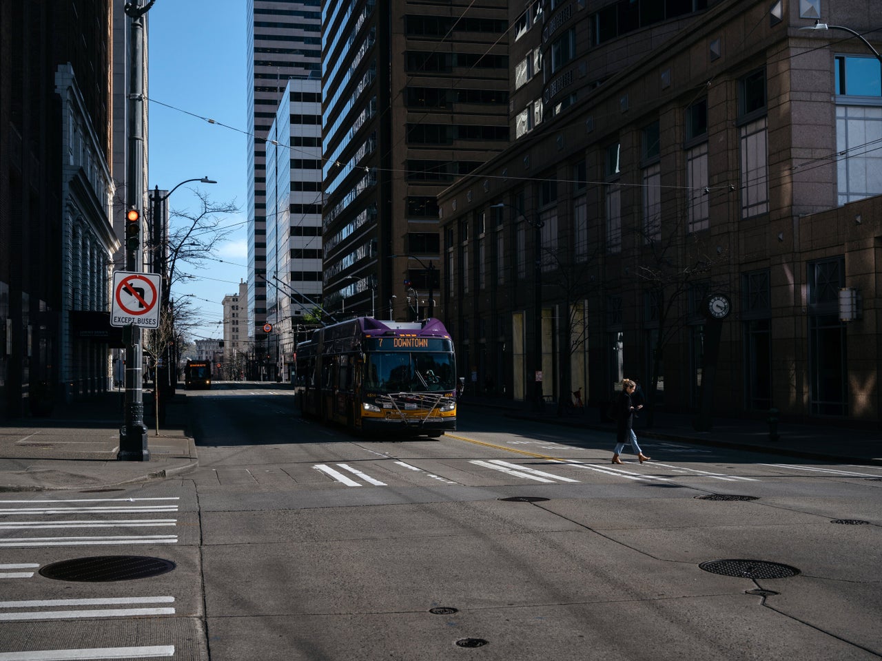 A King County Metro bus drives down 3rd Ave in downtown Seattle during what is usually rush hour.