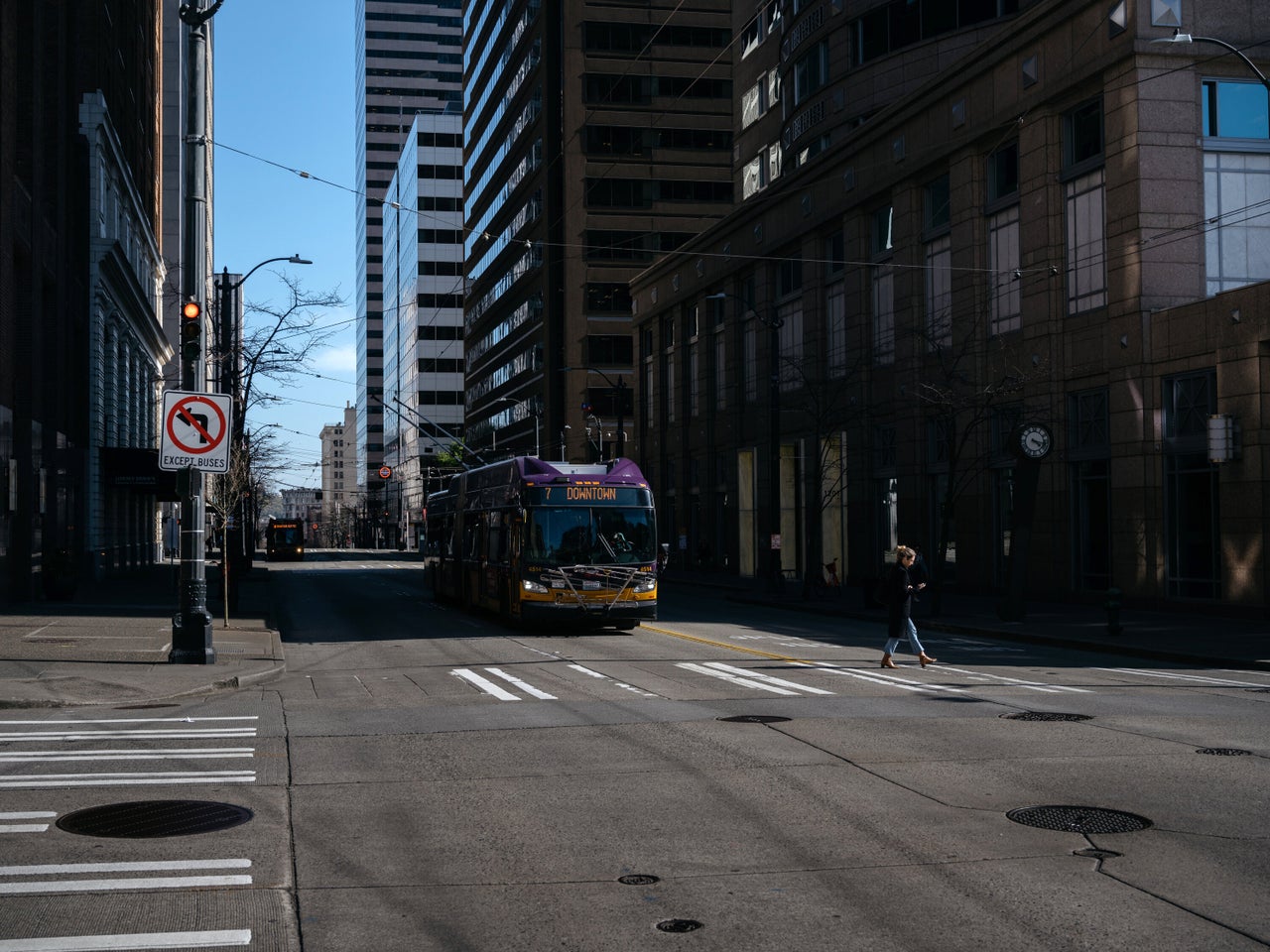 A King County Metro bus drives down 3rd Ave in downtown Seattle during what is usually rush hour. 