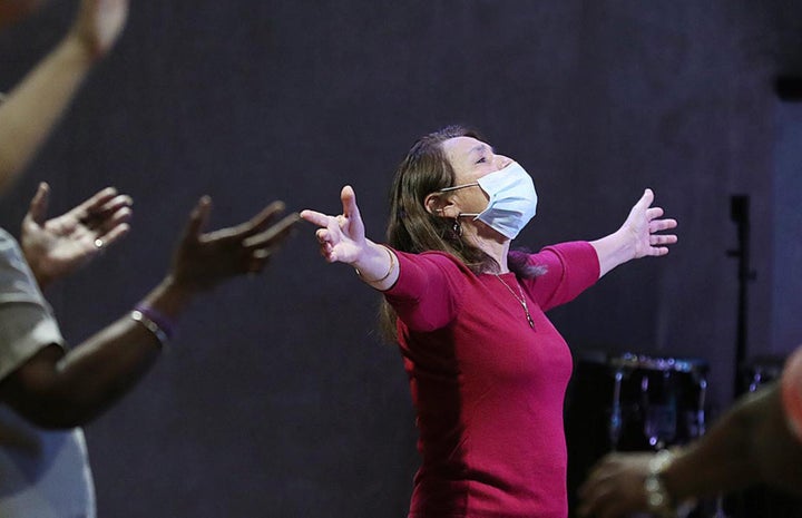 Congregants worship during services at The Center Arena in Orlando on Sunday, April 5, 2020. The church is holding services d