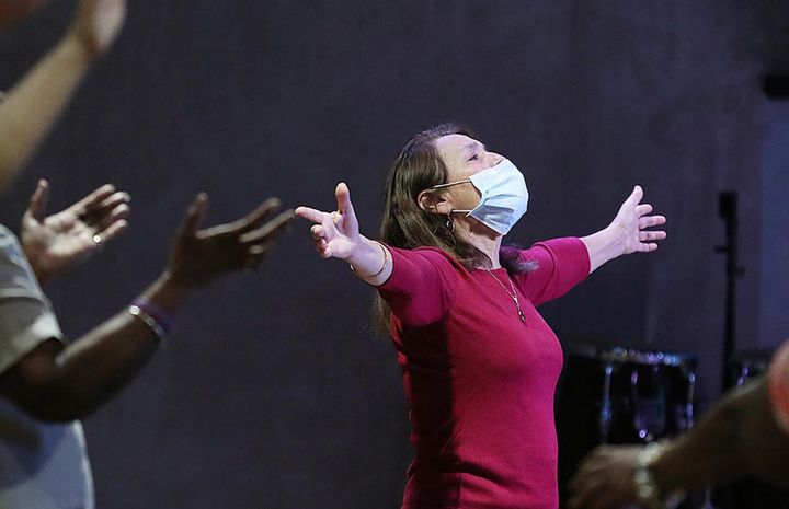 Congregants worship during services at The Center Arena in Orlando on Sunday, April 5, 2020. The church is holding services during the coronavirus epidemic. 