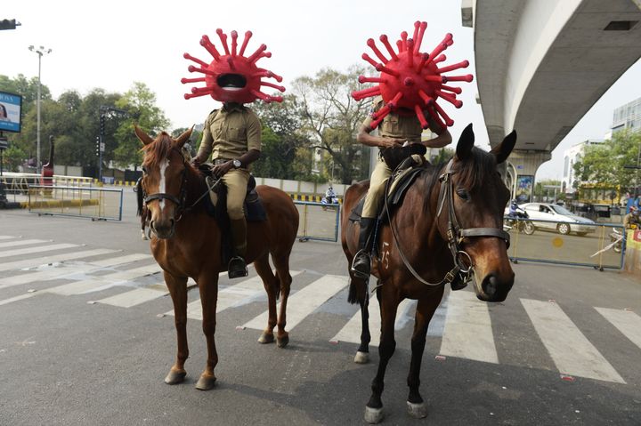 Police personnel wearing coronavirus-themed helmets ride on horses as they participate in an awareness campaign in Secunderabad on April 2, 2020.