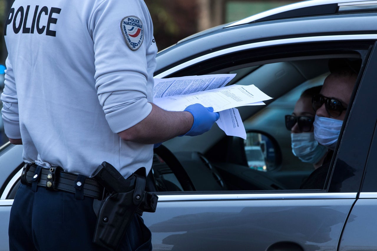 The French government is considering whether to use digital monitoring to help contain the coronavirus. A French police officer is pictured above controlling people near the Parisian ring road