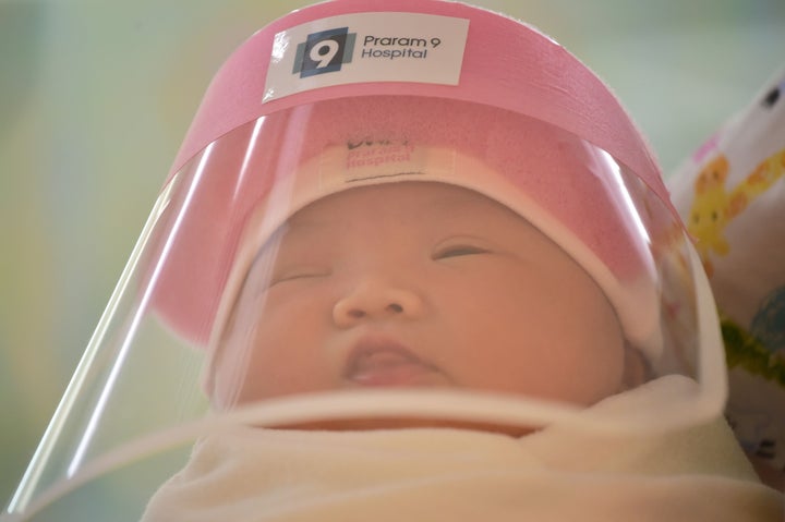 New born baby wearing a tiny face shield in Bangkok - Anadolu Ajansı