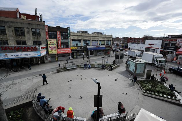 Pedestrians walk Corona Plaza in New York City on April 2, 2020. Data released by city health officials show that residents in largely working class, immigrant neighborhoods of Queens have tested positive for the coronavirus at higher rates than in wealthy, mostly white parts of Manhattan and Brooklyn.