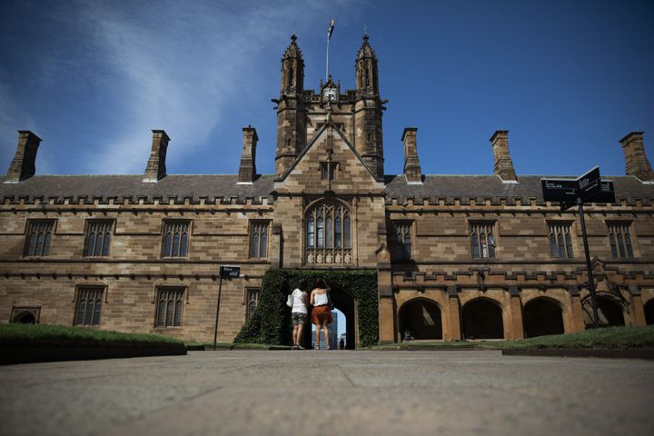 People stand at the quadrangle of the University of Sydney in Sydney, Australia, on Tuesday, Feb. 25, 2020. 