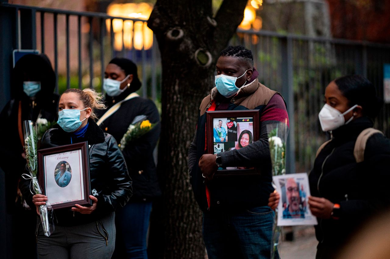 Nurses and healthcare workers mourn and remember their colleagues who died outside Mount Sinai Hospital in Manhattan.