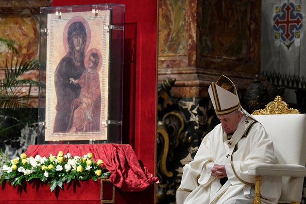 Pope Francis leads the Easter vigil Mass in St. Peter's Basilica with no public participation due to...